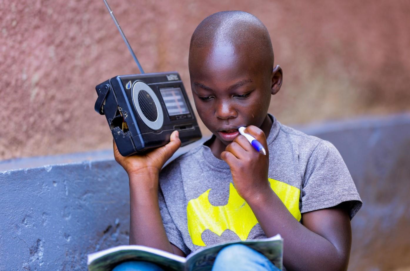 Igihozo Kevin (11) listens to his lessons on the radio every day - Avaz